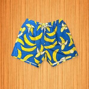 Blue swim trunks featuring a fun banana print from Uzzi